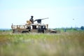 Romanian soldiers man a Humvee armored vehicle on a field, on a sunny summer day during a drill Royalty Free Stock Photo