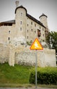 Bobolice castle and road sign with ghost Royalty Free Stock Photo