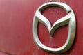 Close-up of the Mazda logo on a car from the 90s. Royalty Free Stock Photo