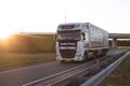 BOBRUISK, BELARUS 26.06.2019: A truck with a trailer transports cargo on the highway at sunset Royalty Free Stock Photo
