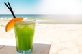Bocal of fruity cocktail on a beach table. exotic summer drinks Royalty Free Stock Photo