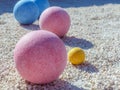 Bocce balls displayed on a gravel court
