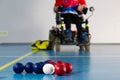 Boccia. A disabled sportsman sitting in a wheelchair. Close up of little balls for playing boccia. Tricolor. Royalty Free Stock Photo