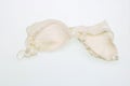 Bodily old  simple rustic female bra lie on white table Royalty Free Stock Photo