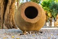 Bodrum cat lies under a huge ancient clay pot in the Saint Peter`s castle