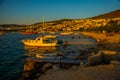 BODRUM, TURKEY: Cityscape on the boardwalk with boat view in the evening at sunset in Bodrum.