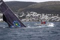 A sailboat sinking into the sea among the waves in a stormy weather. Before that, two boats collide. Royalty Free Stock Photo