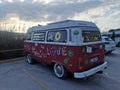 Bodrum, Turkey - 23 December 2022: A red Volkswagen Transporter car painted in hippie style stands in a parking