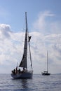 Young man hanging and repairs yacht mast