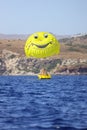 Parasailing on the sea, speed boat and couple on parachute with on mountain background.