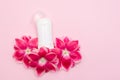 Body antiperspirant deodorant with flowers on pink background with a copy space Royalty Free Stock Photo