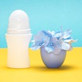 Body antiperspirant deodorant roll-on with flowers in the cap Royalty Free Stock Photo