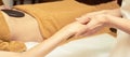 Body arm stone massage. Hot rock masseur. Girl at salon with doctor hands. Relax spa resort Royalty Free Stock Photo