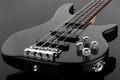 Body of black electric bass guitar on dark background Royalty Free Stock Photo