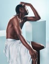 Body, black man and beauty of art and thinking profile in studio with skincare and glow from wellness and towel. Strong Royalty Free Stock Photo