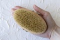 Body brush for dry massage in women& x27;s hands. Brushing body to reduce cellulite, detoxify the lymphatic system, and