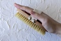 Body brush for dry massage in women& x27;s hands. Brushing body to reduce cellulite, detoxify the lymphatic system, and