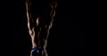 Body brutal bald muscular male bodybuilder closeup on black background, he poses, shows muscles. The view from the back Royalty Free Stock Photo