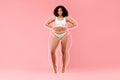 Body care concept. Slim black lady in underwear with drawn silhouette outlines around figure posing on pink background