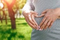 Body care, pregnancy diet concept, female hands forming heart shape on the stomach Royalty Free Stock Photo
