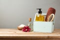 Body care products on wooden table over gray retro background Royalty Free Stock Photo