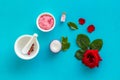 Cream, bath salt, lotion for organic cosmetics with rose flower on blue background top view Royalty Free Stock Photo