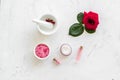 Cream, bath salt, lotion for organic cosmetics with rose flower on white marble background top view Royalty Free Stock Photo