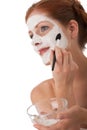 Body care - Young woman apply facial mask