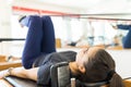 Body Conscious Woman Exercising On Pilates Reformer Machine