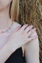 Body details of a beautiful young woman. Shoulder, collarbone and neck. A hand touches the skin. Chain around the neck Royalty Free Stock Photo