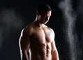 Body, fitness and man with abs in studio with chalk, exercise and healthy from training on black background. Bodybuilder Royalty Free Stock Photo