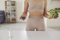 Body and hands of fitness woman athete in sportswear standing holding fresh healthy ingredients Royalty Free Stock Photo