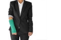 Body injury concept, injured businesswoman with green cast on ha