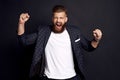 Body language. Beautiful strong bearded caucasian man expressive gesticulating with hands, screaming loudly on stadium, cheering Royalty Free Stock Photo