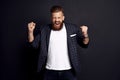 Body language. Beautiful strong bearded caucasian man expressive gesticulating with hands, screaming loudly on stadium, cheering Royalty Free Stock Photo