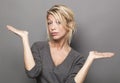 Body language concept for dubious 20s blond woman Royalty Free Stock Photo