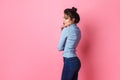 Studio shot of happy young fair-haired woman dressed casually jeans and blue blouse. pink background. copy space Royalty Free Stock Photo