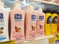 Body lotion in attractive commercial packs displayed for sale in a shop.