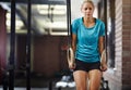 Body and mind over matter. a young woman working out with gymnastics rings in a gym. Royalty Free Stock Photo