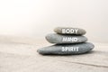 Body, mind and spirit words written on zen stones. Copy space and zen concept Royalty Free Stock Photo