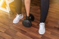 Closeup on woman lifting dumbbell from the floor Royalty Free Stock Photo