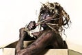 Body painted woman eating a straw