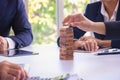 Body part Business engineers plays Jenga game and Orange hat.