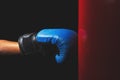 Body part:hand with the blue boxing gloves, dark background Royalty Free Stock Photo