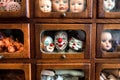 Body parts and faces of crying kids and smiley actors. Dolls inside wooden house for play. Broken toys for game