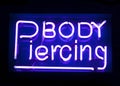 Body piercing neon sign Royalty Free Stock Photo