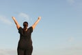 Overweight woman celebrating rising hands to sky