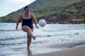 Happy fat woman playing ball on the beach Royalty Free Stock Photo