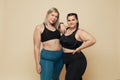 Body Positive. Plus Size Models Portrait. Fat Women In Sport Clothes On Beige Background.