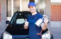 Body repairer holding a spray gun